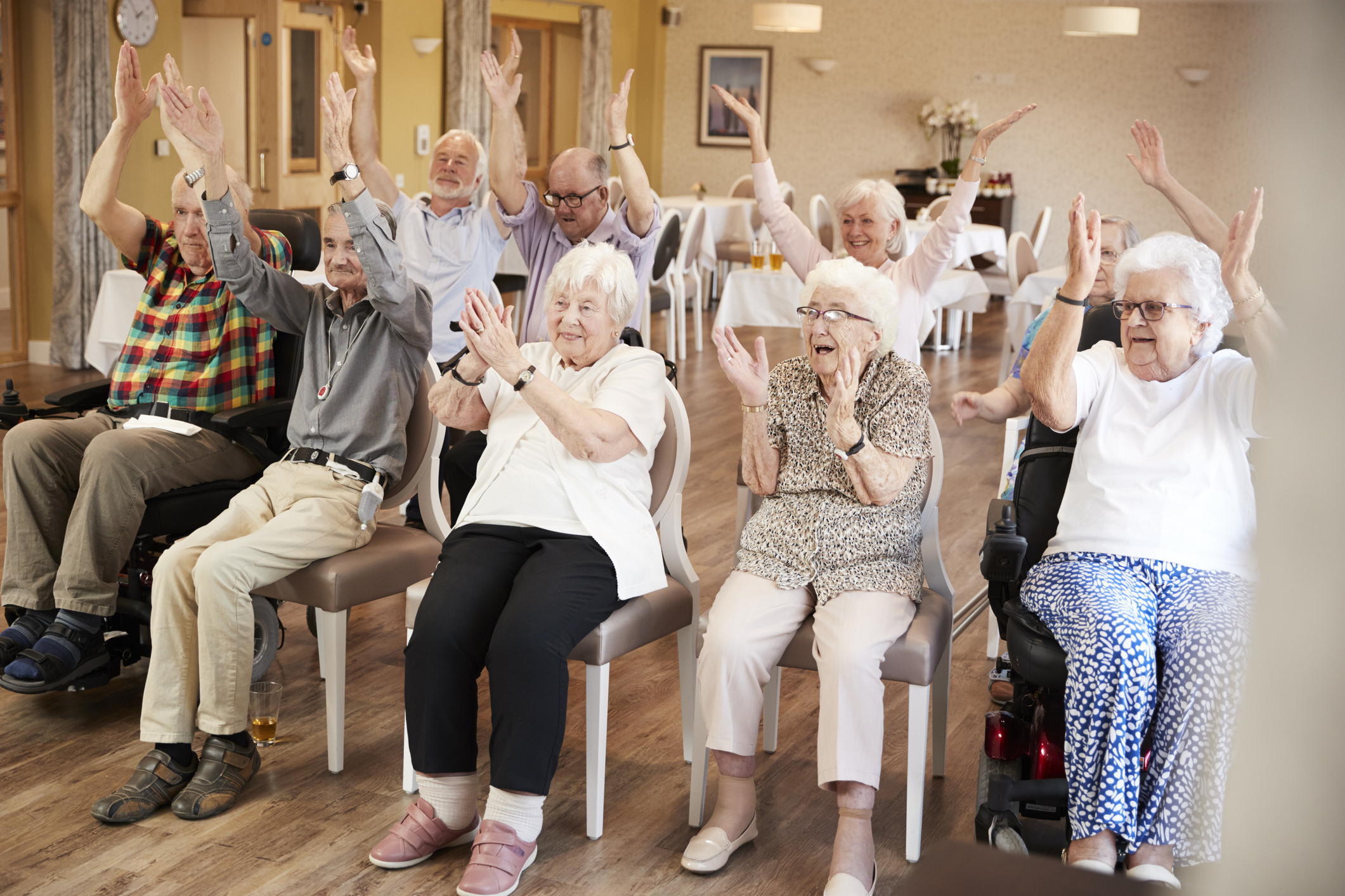 Group Of Seniors Enjoying Fitness Class In Retirement Home Club RCA Adult Respite Day Program
